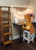 Size: 954x1319 | Tagged: safe, artist:petrichor01, oc, oc only, oc:petrichor, earth pony, pony, chair, earth pony oc, flower, irl, ladder, notebook, photo, ponies in real life, sitting, solo, string lights, studying, table