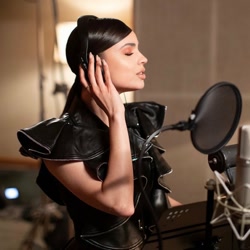 Size: 1066x1066 | Tagged: safe, human, barely pony related, eyes closed, female, headphones, indoors, irl, irl human, microphone, no pony, photo, recording, sofia carson, solo, studio, voice actor
