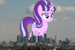 Size: 1023x682 | Tagged: safe, artist:dashiesparkle edit, artist:thegiantponyfan, edit, starlight glimmer, pony, unicorn, g4, california, female, giant pony, giant starlight glimmer, giant unicorn, giantess, highrise ponies, irl, lidded eyes, los angeles, macro, mare, mega giant, multicolored mane, multicolored tail, photo, ponies in real life, s5 starlight, smiling, story included, tail