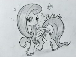 Size: 4160x3120 | Tagged: safe, artist:reekosukanku, fluttershy, pegasus, pony, g4, cursive writing, cute, daaaaaaaaaaaw, full body, heart, high res, looking at you, monochrome, pencil drawing, photo, raised hoof, simple background, smiling, smiling at you, solo, traditional art