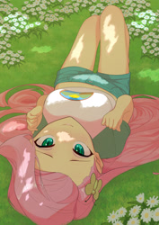 Size: 2480x3508 | Tagged: safe, artist:でかすじ, part of a set, fluttershy, equestria girls, g4, blushing, breasts, busty fluttershy, chamomile, clothes, cute, cutie mark accessory, eyelashes, female, flower, grass, hairclip, high res, long hair, looking at you, lying down, midriff, multiple variants, on back, on ground, outdoors, shirt, shorts, smiling, smiling at you, solo, sunlight, t-shirt, teal eyes
