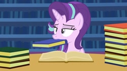 Size: 1438x804 | Tagged: safe, artist:agrol, edit, editor:fluttershyisnot adoormat, starlight glimmer, pony, unicorn, animation:the god of ponies, g4, book, bookshelf, female, mare, mouth hold, nom, solo, starlight glimmer is not amused, unamused
