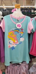 Size: 2752x5664 | Tagged: safe, fluttershy, rainbow dash, pegasus, pony, g4, clothes, duo, female, irl, mare, merchandise, my little pony logo, open mouth, open smile, shirt, smiling, spread wings, t-shirt, text, wings