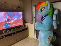Size: 680x510 | Tagged: safe, artist:atalonthedeer, rainbow dash, pegasus, pony, anthro, g4, controller, dead space, female, fursuit, gaming, irl, photo, ponysuit, standing, television, wings