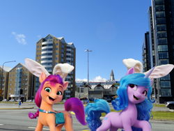 Size: 1920x1440 | Tagged: safe, artist:a-new-generation-in-real-life fan, izzy moonbow, sunny starscout, earth pony, pony, unicorn, g5, my little pony: a new generation, bag, bunny ears, duo, easter, easter egg, female, holiday, horn, iceland, irl, long description, looking at you, mare, open mouth, open smile, photo, ponies in real life, saddle bag, smiling, story included