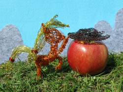 Size: 2191x1644 | Tagged: safe, artist:malte279, part of a set, applejack, earth pony, pony, g4, apple, cowboy hat, craft, female, food, grass, hat, hoof hold, irl, mare, photo, rearing, solo, stetson, wire sculpture