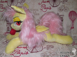 Size: 1024x766 | Tagged: safe, artist:allunacraft, fluttershy, bat pony, apple, bat ponified, bedroom eyes, flutterbat, folded wings, food, irl, looking at you, lying down, messy mane, mouth hold, photo, plushie, race swap, solo, wings