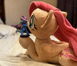 Size: 1703x1463 | Tagged: safe, photographer:xbi, fluttershy, trixie, pegasus, pony, g4, bed, cape, clothes, digital art, figurine, hat, irl, mixed media, on bed, photo, plushie, trixie's cape, trixie's hat, welovefine