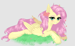 Size: 1280x787 | Tagged: safe, artist:sufflle, fluttershy, pegasus, pony, g4, aside glance, beige background, cheek fluff, ear fluff, female, flower, flower in hair, grass, grin, looking at you, lying down, mare, prone, simple background, smiling, solo, wings