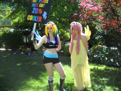 Size: 2828x2121 | Tagged: safe, artist:arcticshadowfox, fluttershy, rainbow dash, human, g4, 20% cooler, bare shoulders, belly button, clothes, converse, cosplay, costume, duo, everfree northwest, everfree northwest 2014, high res, irl, irl human, multicolored hair, photo, picket sign, rainbow hair, shoes, sports bra