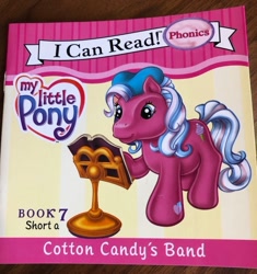 Size: 900x957 | Tagged: safe, artist:ken edwards, cotton candy (g3), earth pony, pony, g3, official, beret, book, book cover, cotton candy's band, cover, female, food, hat, heart, heart eyes, i can read, ice cream, irl, mare, merchandise, my little pony logo, phonics, photo, raised hoof, sheet music, smiling, sparkles, stand, text, wingding eyes