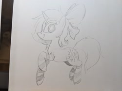 Size: 2048x1536 | Tagged: safe, artist:mellodillo, oc, oc only, pony, unicorn, bow, clothes, female, grayscale, hair bow, looking at you, mare, monochrome, pencil drawing, smiling, socks, solo, striped socks, traditional art