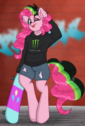 Size: 1846x2723 | Tagged: safe, artist:ponykittenboi, derpibooru exclusive, pinkie pie, earth pony, semi-anthro, g4, ;p, alternate hairstyle, arm behind head, arm hooves, bipedal, brick wall, clothes, denim, denim shorts, dyed mane, dyed tail, ear fluff, ear piercing, eyeshadow, graffiti, hoodie, logo, makeup, monster energy, one eye closed, piercing, punkie pie, shitposting, shorts, skateboard, solo, tail, tongue out, torn clothes, wink