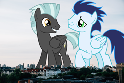 Size: 1900x1267 | Tagged: safe, artist:chainchomp2 edits, artist:thegiantponyfan, edit, soarin', thunderlane, pegasus, pony, g4, berlin, duo, folded wings, germany, giant pegasus, giant pony, grin, highrise ponies, irl, macro, male, mega giant, photo, ponies in real life, smiling, stallion, wings