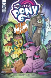 Size: 1265x1920 | Tagged: safe, idw, official comic, apple bloom, queen chrysalis, scootaloo, sweetie belle, twilight sparkle, alicorn, changeling, changeling queen, earth pony, pony, unicorn, g4, official, the return of queen chrysalis, spoiler:comic, anniversary, book, candle, cave, comic cover, cutie mark crusaders, facehoof, female, happy, smiling, speech bubble, twilight sparkle (alicorn)