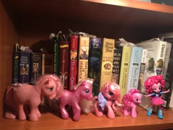 Size: 1280x960 | Tagged: safe, cotton candy (g1), pinkie pie, pinkie pie (g3), earth pony, pony, equestria girls, g1, g3, g3.5, g4, book, bookshelf, bow, clothes, cottoncandybetes, cute, diapinkes, doll, equestria girls minis, female, g3 diapinkes, irl, mare, multeity, one eye closed, photo, skirt, tail, tail bow, toy, wink