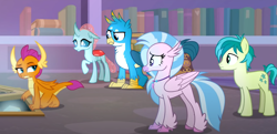Size: 1283x620 | Tagged: safe, screencap, gallus, ocellus, sandbar, silverstream, smolder, changedling, changeling, classical hippogriff, dragon, earth pony, griffon, hippogriff, pony, g4, what lies beneath, cropped, smolder is not amused, unamused