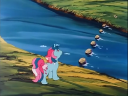 Size: 961x721 | Tagged: safe, screencap, fizzy, butterfly, pony, unicorn, g1, my little pony 'n friends, the return of tambelon, bow, river, stepping stones, stream, tail, tail bow, water