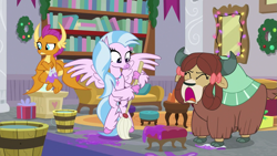 Size: 1279x719 | Tagged: safe, screencap, silverstream, smolder, yona, classical hippogriff, dragon, hippogriff, yak, g4, the hearth's warming club, bookshelf, bow, bucket, cloven hooves, colored hooves, crossed arms, hair bow, jewelry, monkey swings, mop, necklace, open mouth, raised eyebrow, screaming, string lights, trio