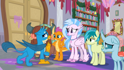 Size: 1600x900 | Tagged: safe, screencap, gallus, ocellus, sandbar, silverstream, smolder, yona, changedling, changeling, classical hippogriff, dragon, earth pony, griffon, hippogriff, pony, yak, g4, the hearth's warming club, bookshelf, bow, butt, cloven hooves, colored hooves, dragoness, female, gallass, hair bow, hand on hip, jewelry, male, monkey swings, necklace, plot, student six