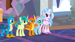 Size: 1600x899 | Tagged: safe, screencap, gallus, ocellus, sandbar, silverstream, smolder, changedling, changeling, classical hippogriff, dragon, earth pony, griffon, hippogriff, pony, g4, uprooted, colored hooves, dragoness, female, jewelry, male, necklace, school of friendship, shrug