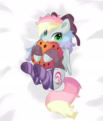 Size: 1745x2048 | Tagged: safe, artist:latia122, oc, oc only, oc:blazey sketch, bow, clothes, cookie, food, gray fur, green eyes, hair bow, lying down, multicolored hair, small wings, smiling, socks, solo, striped socks, sweater, wings