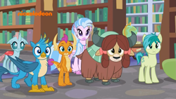 Size: 1249x703 | Tagged: safe, screencap, gallus, ocellus, sandbar, silverstream, smolder, yona, changedling, changeling, classical hippogriff, dragon, earth pony, griffon, hippogriff, pony, yak, g4, what lies beneath, bookshelf, bow, cloven hooves, globe, hair bow, jewelry, logo, monkey swings, necklace, nickelodeon, offscreen character, student six