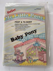 Size: 1536x2048 | Tagged: safe, baby pony (g1), earth pony, pony, g1, baby, baby pony, blue eyes, bow, brush, building blocks, crib mobile, dresser, female, filly, foal, irl, my little pony logo, photo, rocking horse, solo, sticker pack, swedish, tail, tail bow, toy, window