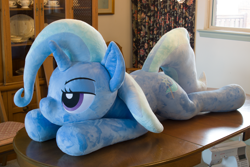 Size: 5184x3456 | Tagged: safe, artist:azgchip, trixie, pony, unicorn, g4, bedroom eyes, female, irl, life size, lying down, mare, photo, plushie, prone, solo, sploot, table