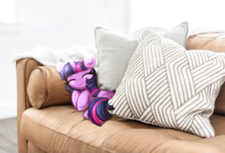 Size: 939x640 | Tagged: safe, artist:confetticakez, twilight sparkle, pony, unicorn, g4, couch, cute, eyes closed, female, floppy ears, irl, lying down, mare, on side, photo, ponies in real life, sleeping, smiling, smol, solo, twiabetes, unicorn twilight