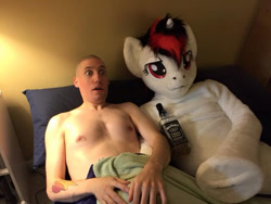 Size: 640x480 | Tagged: safe, artist:atalonthedeer, oc, oc only, oc:blackjack, human, pony, unicorn, anthro, fallout equestria, fallout equestria: project horizons, 2015, aftermath, bald, bed, bedroom eyes, duo, embarrassed, female, fursuit, hangover, human exhibitionism, human nudity, human on pony snuggling, in bed, interspecies, irl, irl human, jack daniels, male, morning after, nipples, nudity, photo, ponysuit, shocked, snuggling, straight, tattoo