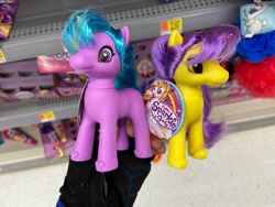 Size: 1280x960 | Tagged: safe, human, unicorn, bootleg, colored horn, duo, female, hand, hoof shoes, horn, incorrect hair placement, irl, irl human, mare, photo, shelf, toy, zuru sparkle girlz