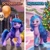 Size: 1080x1080 | Tagged: safe, izzy moonbow, pony, unicorn, g5, my little pony: a new generation, my little pony: make your mark, official, balloon, christmas, christmas lights, christmas tree, crystal brighthouse, cute, devil horns, female, halloween, hat, holiday, horns, izzybetes, mare, meme, october 31st vs. november 1st, open mouth, open smile, pumpkin, santa hat, smiling, solo, text, tree