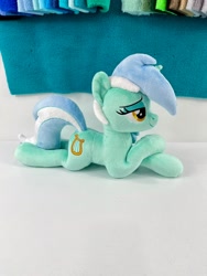 Size: 1536x2048 | Tagged: safe, artist:kazzysplush, lyra heartstrings, pony, unicorn, g4, background pony, eyelashes, female, for sale, irl, lying down, mare, photo, plushie, prone, sitting, smiling, solo