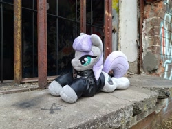 Size: 3728x2796 | Tagged: safe, maud pie, earth pony, pony, g4, abandoned, choker, clothes, high res, irl, jacket, leather, leather jacket, lying down, metal, metalhead, photo, plushie, prone, spiked choker, sploot, window
