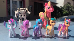 Size: 1196x668 | Tagged: safe, artist:dingopatagonico, big macintosh, hitch trailblazer, izzy moonbow, pipp petals, sunny starscout, zipp storm, earth pony, pegasus, pony, unicorn, g4, g5, gasaraki, irl, ishtar tactical armor, photo, toy