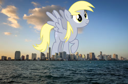 Size: 1600x1056 | Tagged: safe, artist:sketchmcreations, edit, editor:jaredking779, derpy hooves, pegasus, pony, g4, background pony, female, florida, giant pony, giantess, highrise ponies, irl, macro, mare, miami, ocean, photo, ponies in real life, solo, spread wings, story included, water, wings