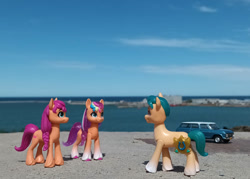 Size: 1057x756 | Tagged: safe, artist:dingopatagonico, hitch trailblazer, sunny starscout, earth pony, pony, g5, argentina, female, male, mane stripe sunny, mare, photo, self paradox, self ponidox, stallion, toy, trio