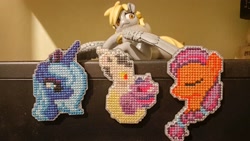 Size: 4080x2304 | Tagged: safe, artist:kujivunia, derpy hooves, discord, princess luna, sunny starscout, twilight sparkle, alicorn, earth pony, pegasus, pony, g4, g5, craft, cross stitch, eyes closed, figurine, fridge magnet, hug, kissing, looking at each other, looking at someone, magnet icon, statuette