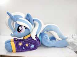Size: 4624x3472 | Tagged: safe, artist:lanacraft, trixie, pony, unicorn, g4, alternate hairstyle, babysitter trixie, clothes, hoodie, irl, lying down, photo, plushie, prone, smiling, solo, sploot