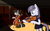 Size: 1920x1187 | Tagged: safe, artist:truthormare, inky rose, lily lace, octavia melody, earth pony, pony, unicorn, g4, bowtie, cello, clothes, dress, female, mare, musical instrument, performance, playing instrument, ponerpics import, simple background, solo, spotlight, stage, violin