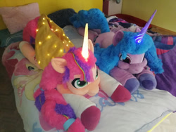 Size: 1280x960 | Tagged: safe, artist:aggsweb, fluttershy, izzy moonbow, sunny starscout, twilight sparkle, alicorn, pony, sea pony, unicorn, g4, g5, bed, blanket, cute, duo, female, glowing, glowing horn, horn, irl, izzybetes, life size, lights, lying down, mane stripe sunny, mare, photo, pillow, plushie, prone, race swap, sunnybetes, sunnycorn, unshorn fetlocks