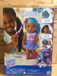 Size: 1500x2000 | Tagged: safe, izzy moonbow, human, pony, unicorn, g5, baby alive, dark skin, female, irl, irl human, merchandise, photo, toy