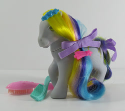 Size: 674x600 | Tagged: safe, ringlets (g1), earth pony, pony, g1, barrette, bow, brush, brush 'n grow ponies, comb, female, hair bow, irl, mane, mare, photo, raised hoof, smiling, tail, tail bow, toy