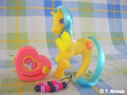 Size: 761x565 | Tagged: safe, springly, earth pony, pony, g2, bead machine, beads, comb, female, irl, mare, photo, raised hoof, smiling, solo, tail, toy, unshorn fetlocks
