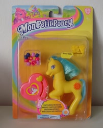 Size: 800x991 | Tagged: safe, springly, earth pony, pony, g2, bead machine, beads, comb, female, french, irl, mare, merchandise, packaging, photo, raised hoof, smiling, solo, tail, toy, unshorn fetlocks