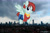 Size: 2048x1365 | Tagged: safe, anonymous editor, artist:cheezedoodle96, edit, valley glamour, pegasus, pony, g4, background pony, bracelet, clothes, denim, denim shorts, female, giant pony, giantess, grin, highrise ponies, indonesia, irl, jakarta, jewelry, looking at you, macro, mare, midriff, photo, ponies in real life, shirt, shorts, smiling, solo, spread wings, wings