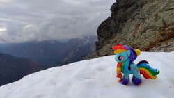 Size: 1192x670 | Tagged: safe, artist:mgrdash, rainbow dash, pegasus, pony, g4, clothes, endangering plushies, irl, mountain, photo, plushie, ponies around the world, ponies in real life, snow, solo