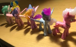 Size: 2301x1437 | Tagged: safe, dazzle feather, queen haven, ruddy sparks, shutter snap, zoom zephyrwing, pegasus, pony, g5, crown, crystal, desk, fake horn, female, funny, group, irl, jewelry, lamp, line-up, male, mare, necklace, pegasus crystal, photo, quintet, random, regalia, stallion, sunglasses, toy, unshorn fetlocks, wat, weird