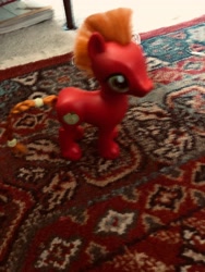 Size: 3024x4032 | Tagged: safe, big macintosh, earth pony, pony, g4, applejacks's brother, bad camera quality, blurry, book, braid, braided tail, carpet, hair tie, irl, male, mohawk, photo, solo, stallion, tail, toy